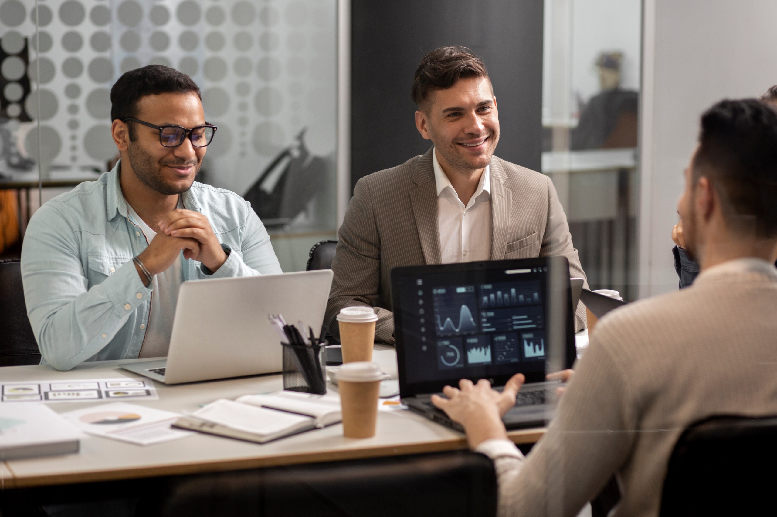 Three men in a business meeting with laptops - MaherTech Inc (Animation)
